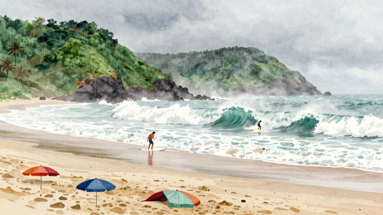 Surfer riding a large monsoon wave at Arambol Beach under rainy, misty green hills.