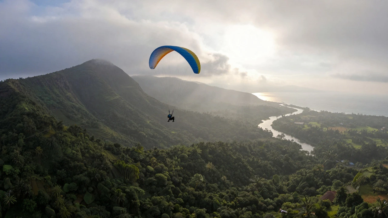 Paraglider flying over misty Western Ghats mountains near Thiruvananthapuram.